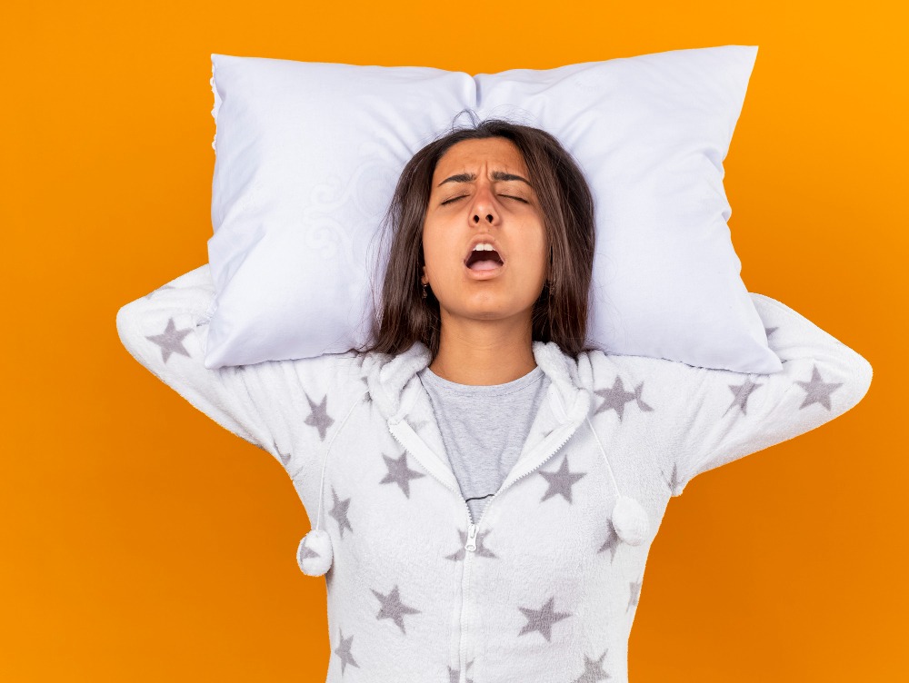 Woman sleeping with mouth open, illustrating a possible sleep apnea symptom in women